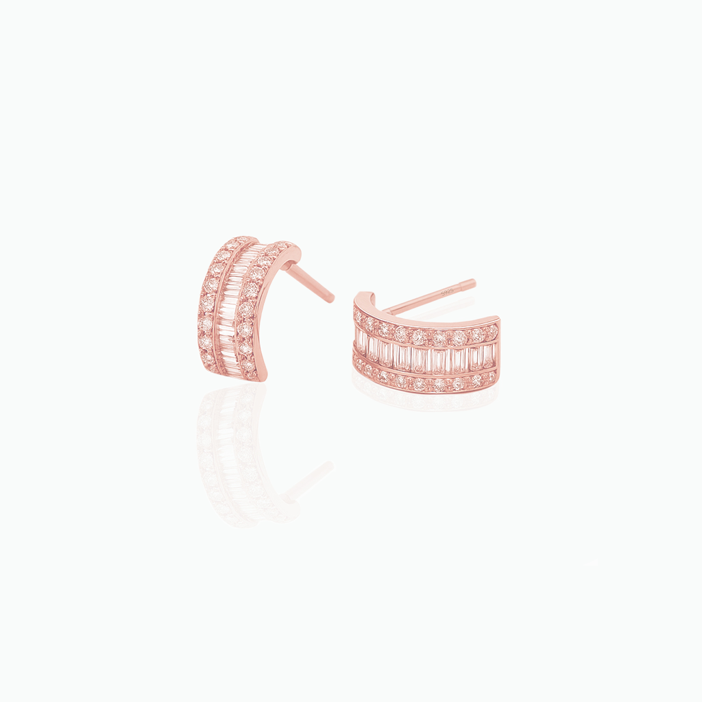 Rose gold hoop earrings with embedded stones on a white background