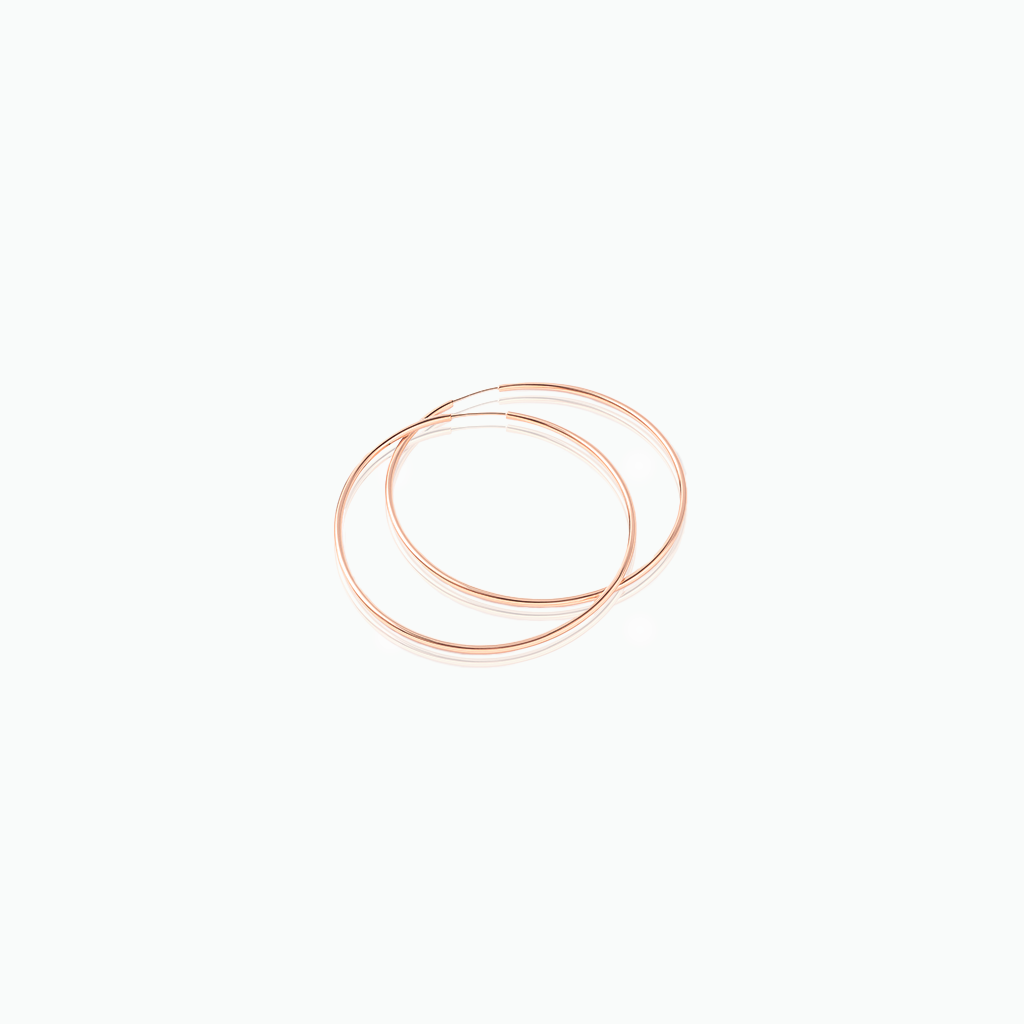Two rose gold hoop earrings on a white background