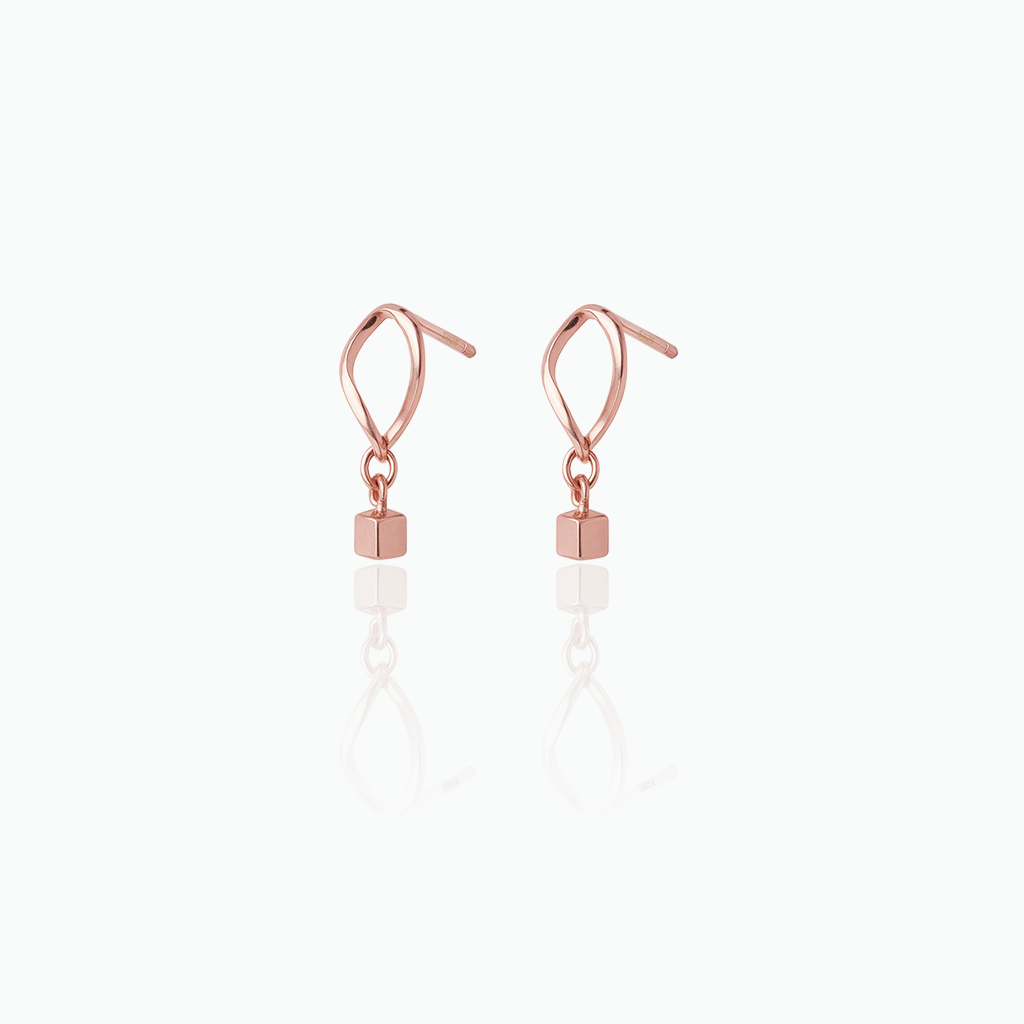 Rose gold earrings with small square beads on a white background