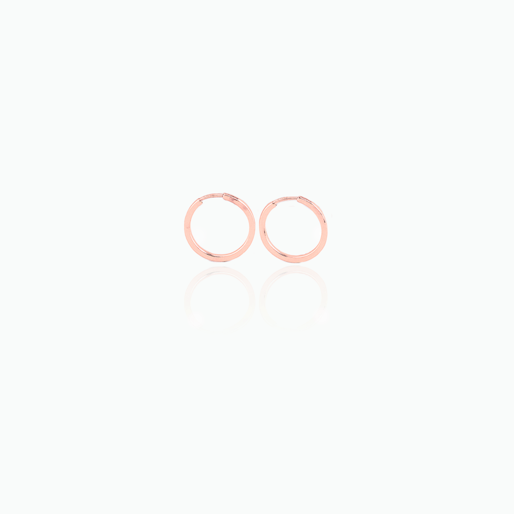 Pair of rose gold hoop earrings on a white background