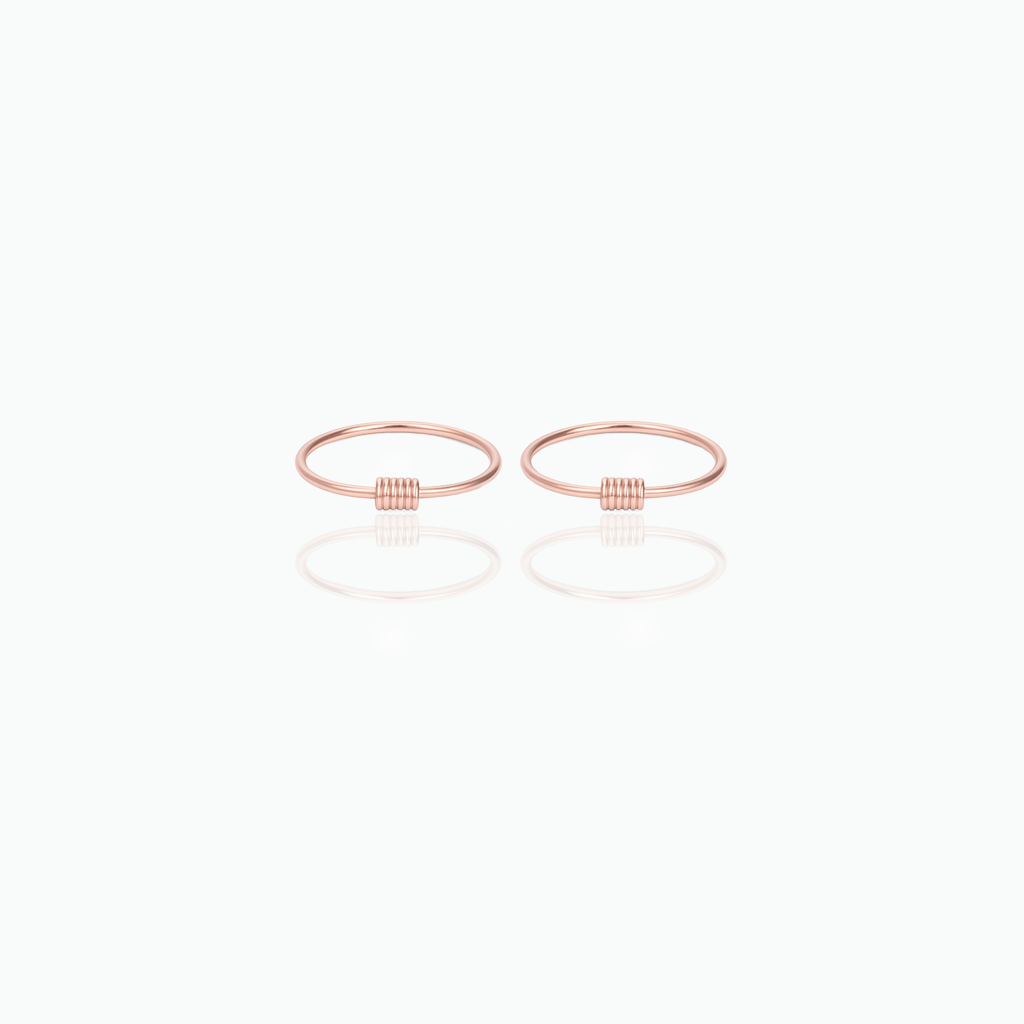 Pair of rose gold hoop earrings on a white background