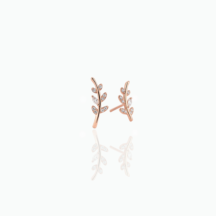 Rose gold leaf-shaped earrings on a white background