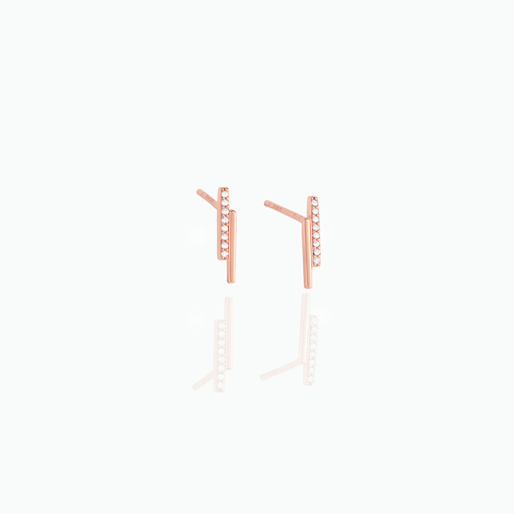 Rose gold earrings on a white background