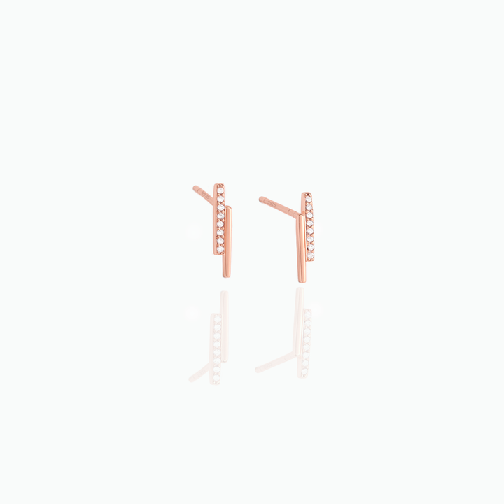 Rose gold earrings on a white background