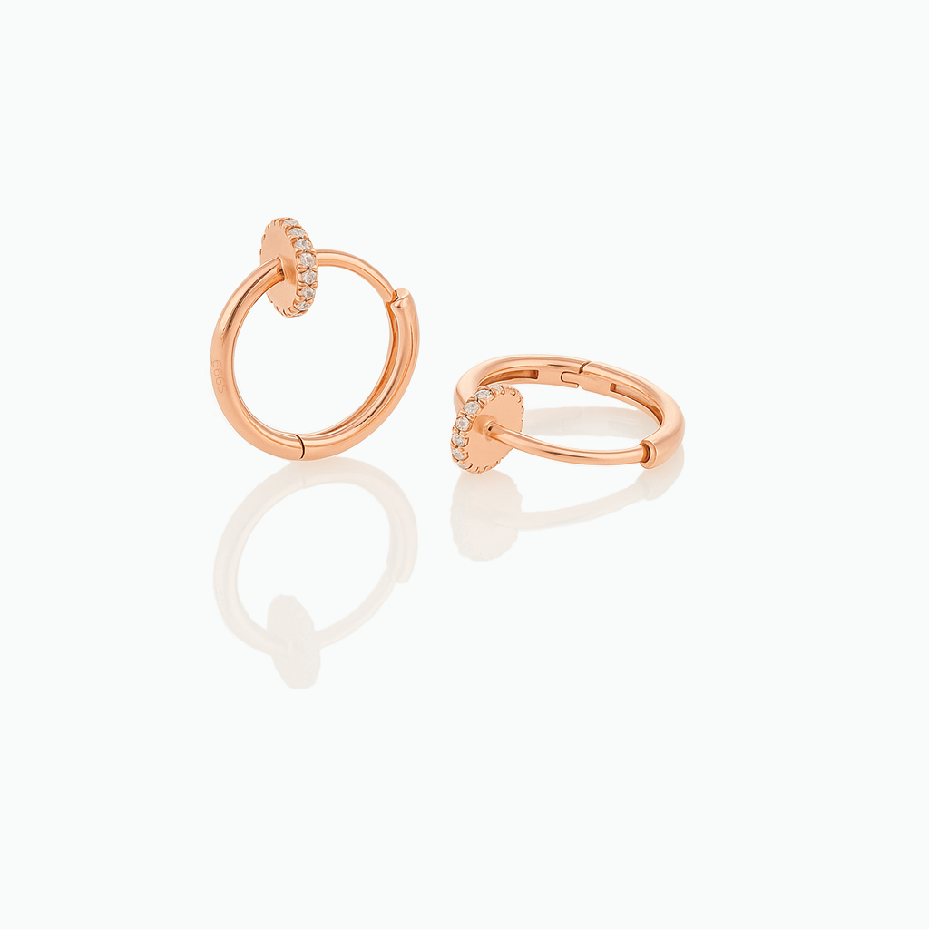 Rose gold hoop earrings on a white background