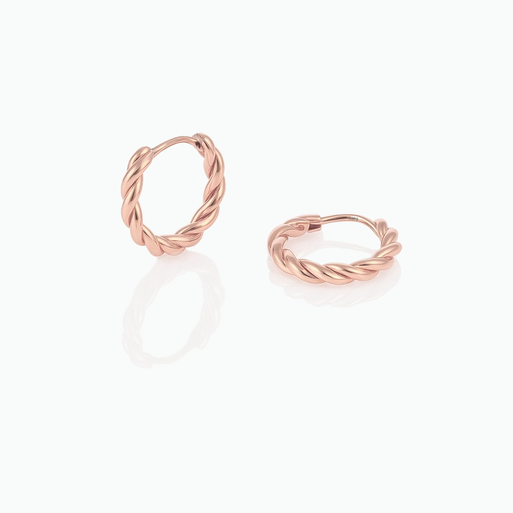 Rose gold hoop earrings on a white background