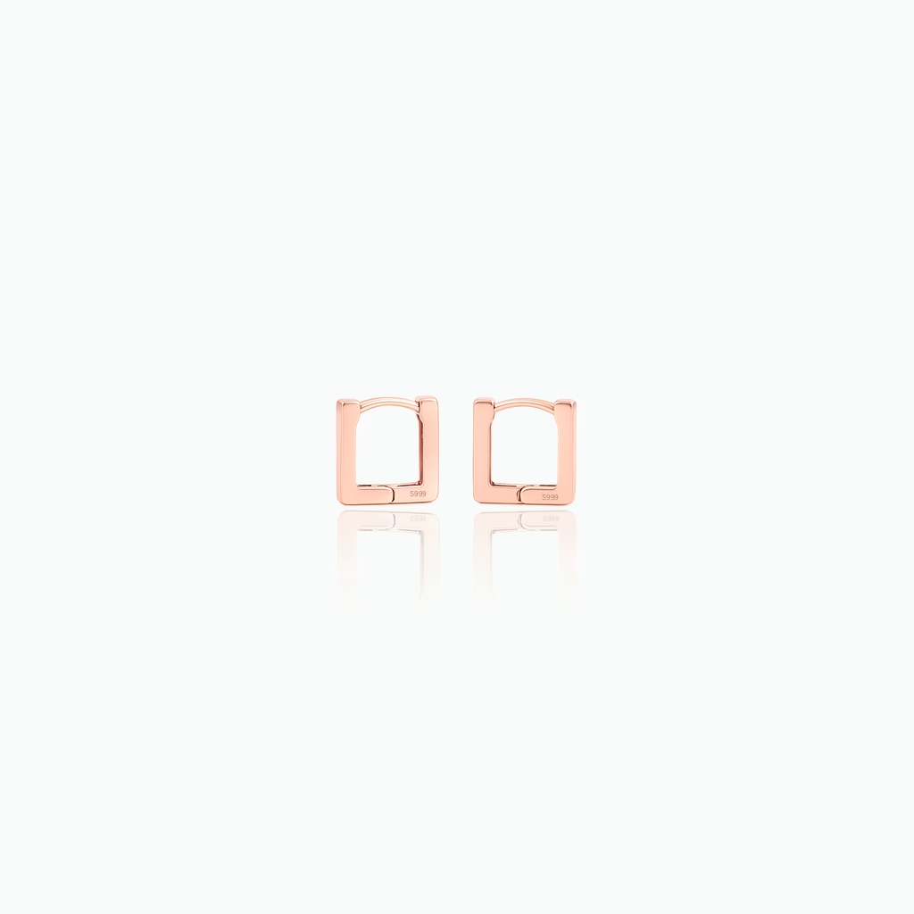Rose gold square hoop earrings on a white background