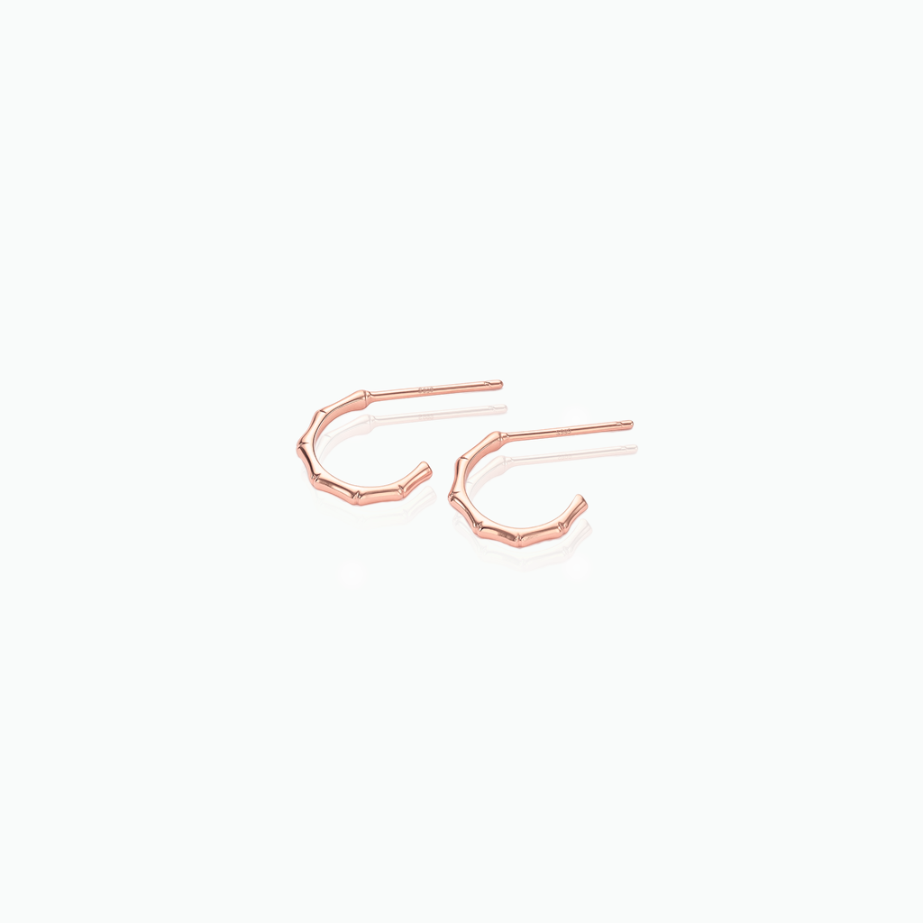 Rose gold hoop earrings on a white background