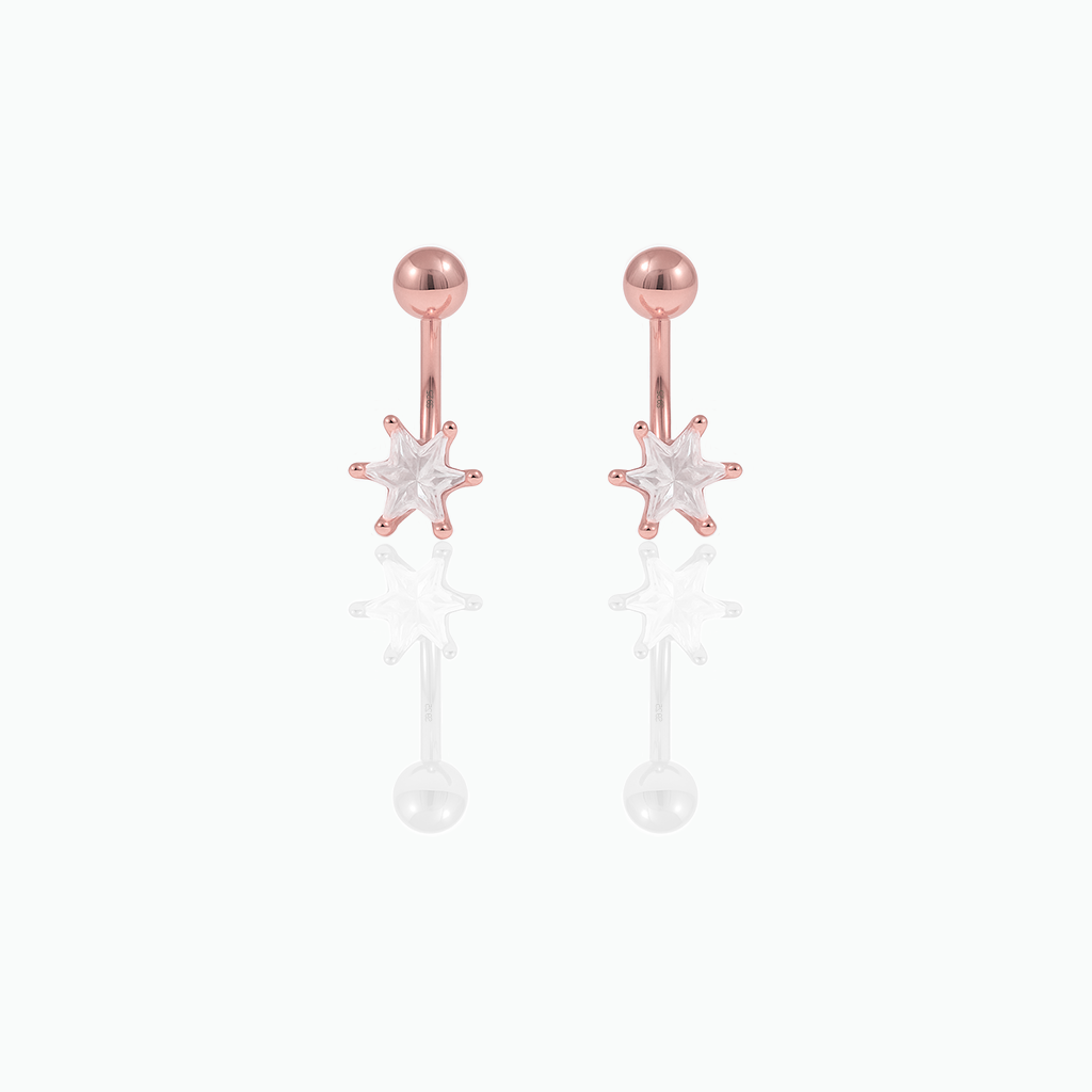 Rose gold earrings with star designs on a white background