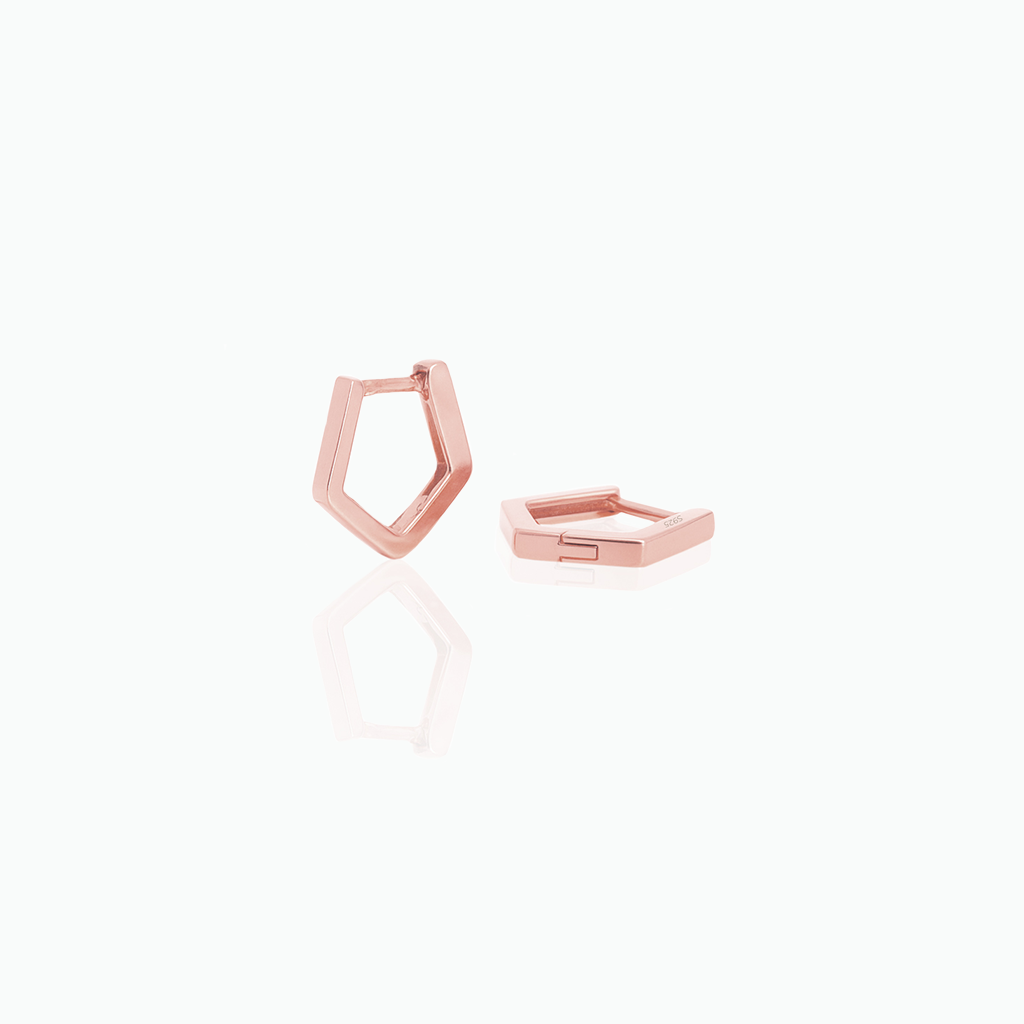 Rose gold geometric huggie hoop earrings on a white background