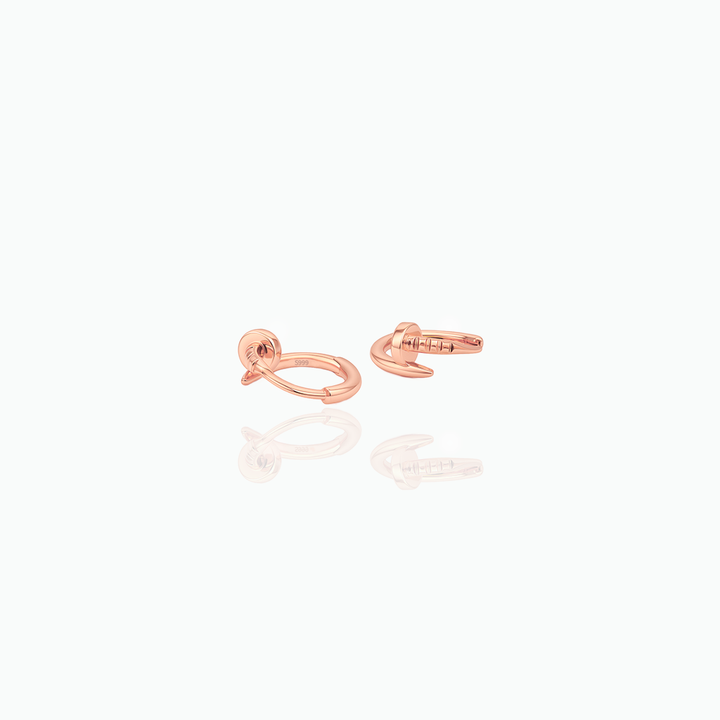 Rose gold earrings on a white  background