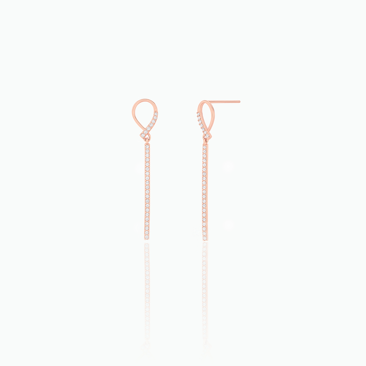 Pair of rose gold earrings on a white background