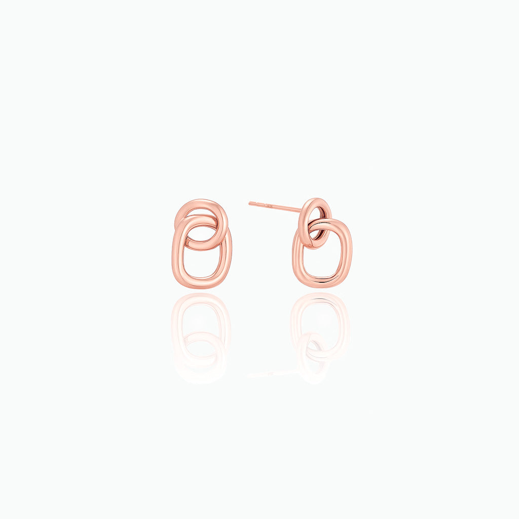 Rose gold earrings on a white background