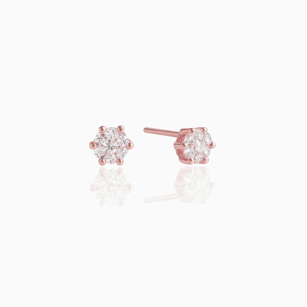 Rose gold stud earrings with clear gemstones on a white background