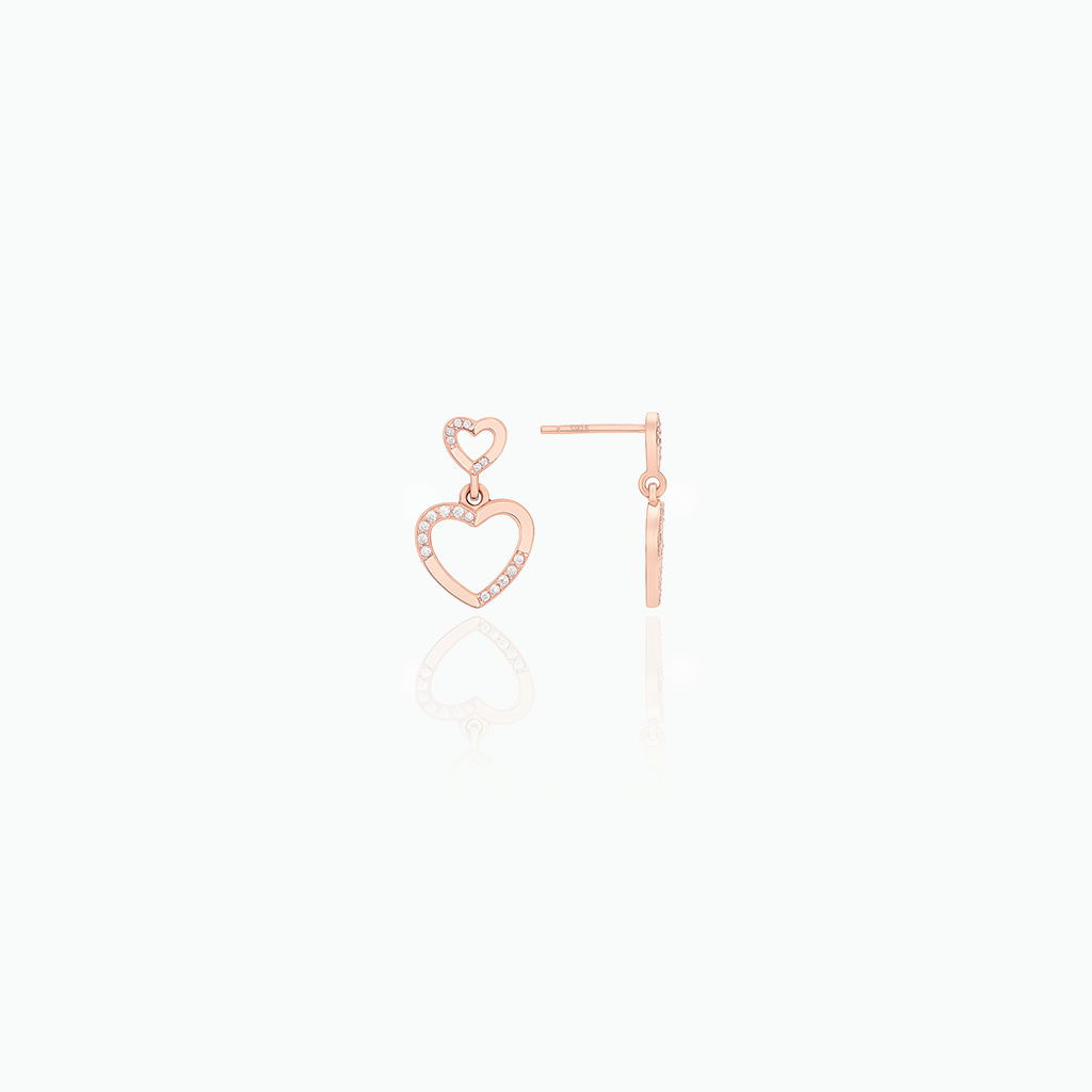 Rose gold heart-shaped earrings on a white background