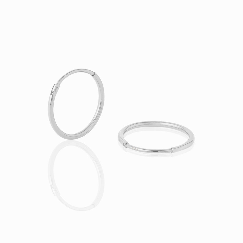 Two silver hoop earrings on a white background