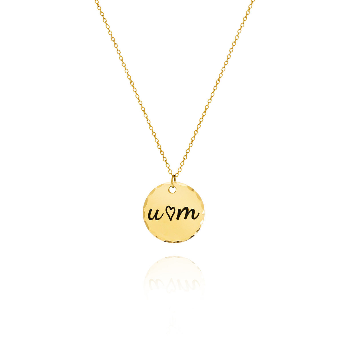 Gold-tone round disc necklace with hammered edge, engraved U, a heart, and M on a white background