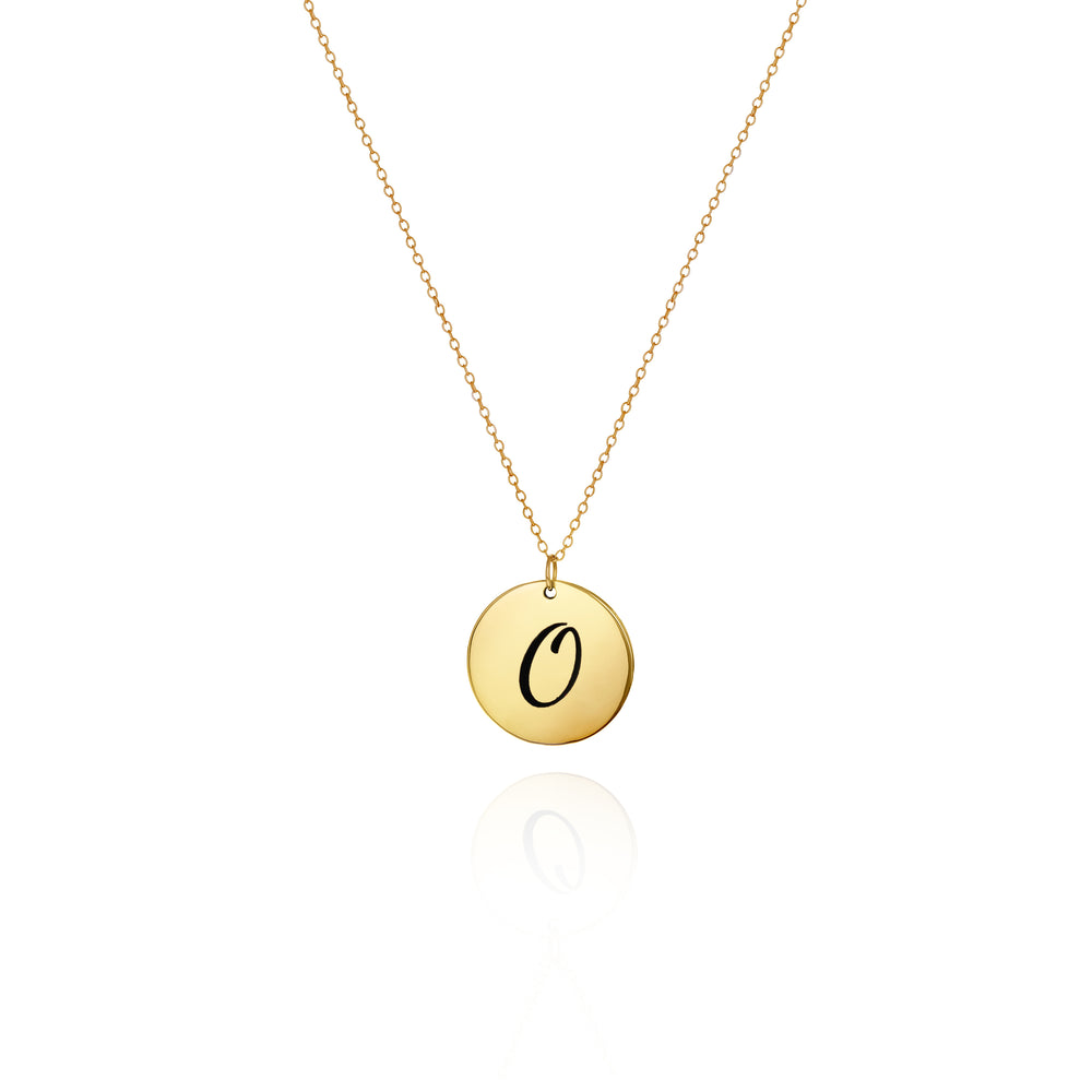 A gold necklace with a disc pendant engraved with the initial 'O' on a white background.