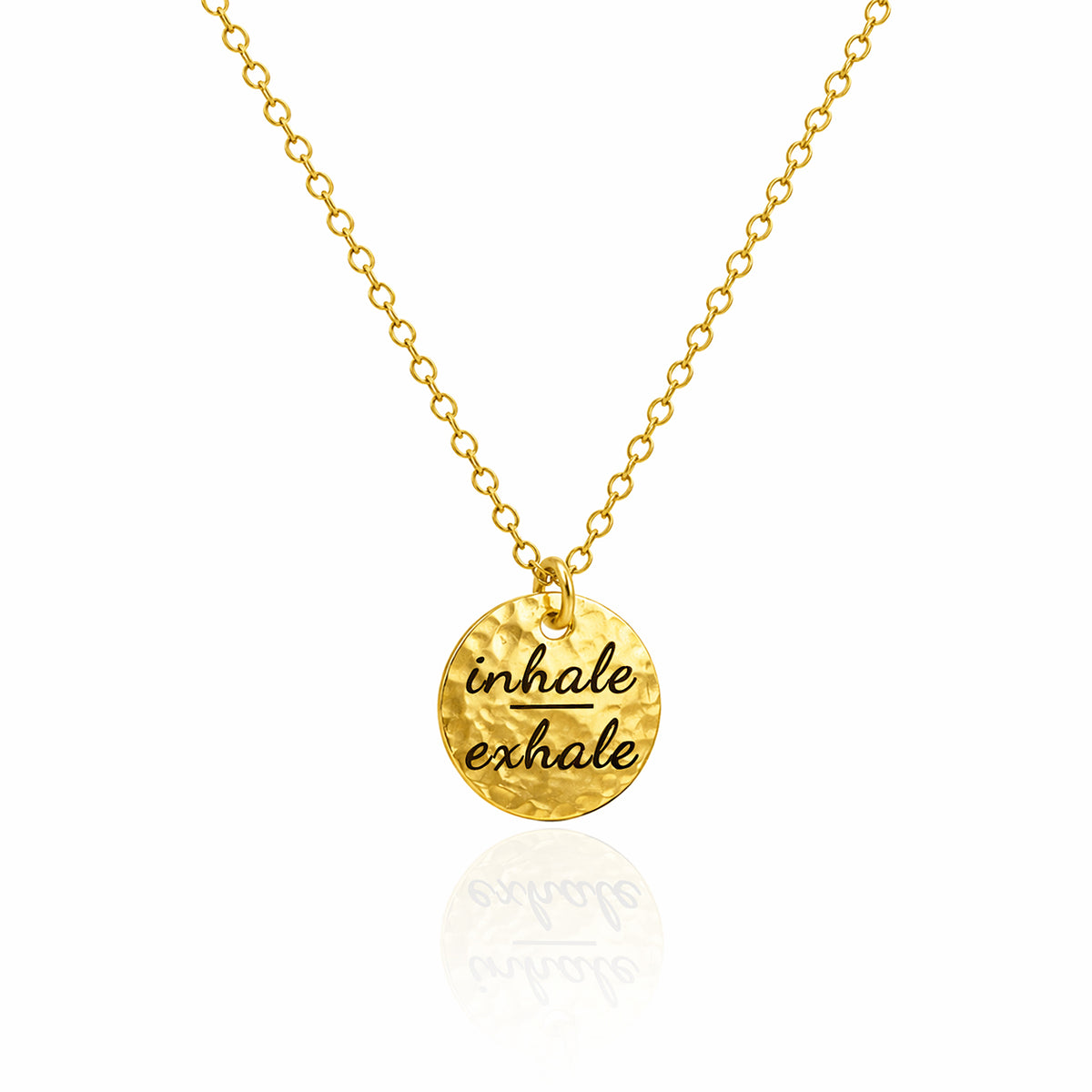 Gold-tone hammered round disc necklace engraved inhale exhale on a white background