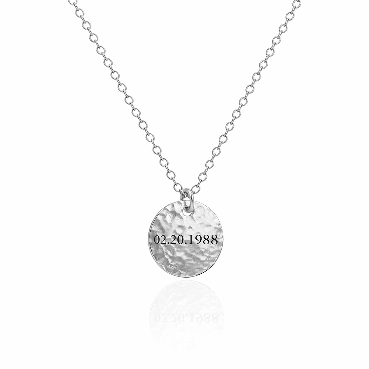 Silver-tone hammered round disc necklace engraved 02.20.1988 on a white background