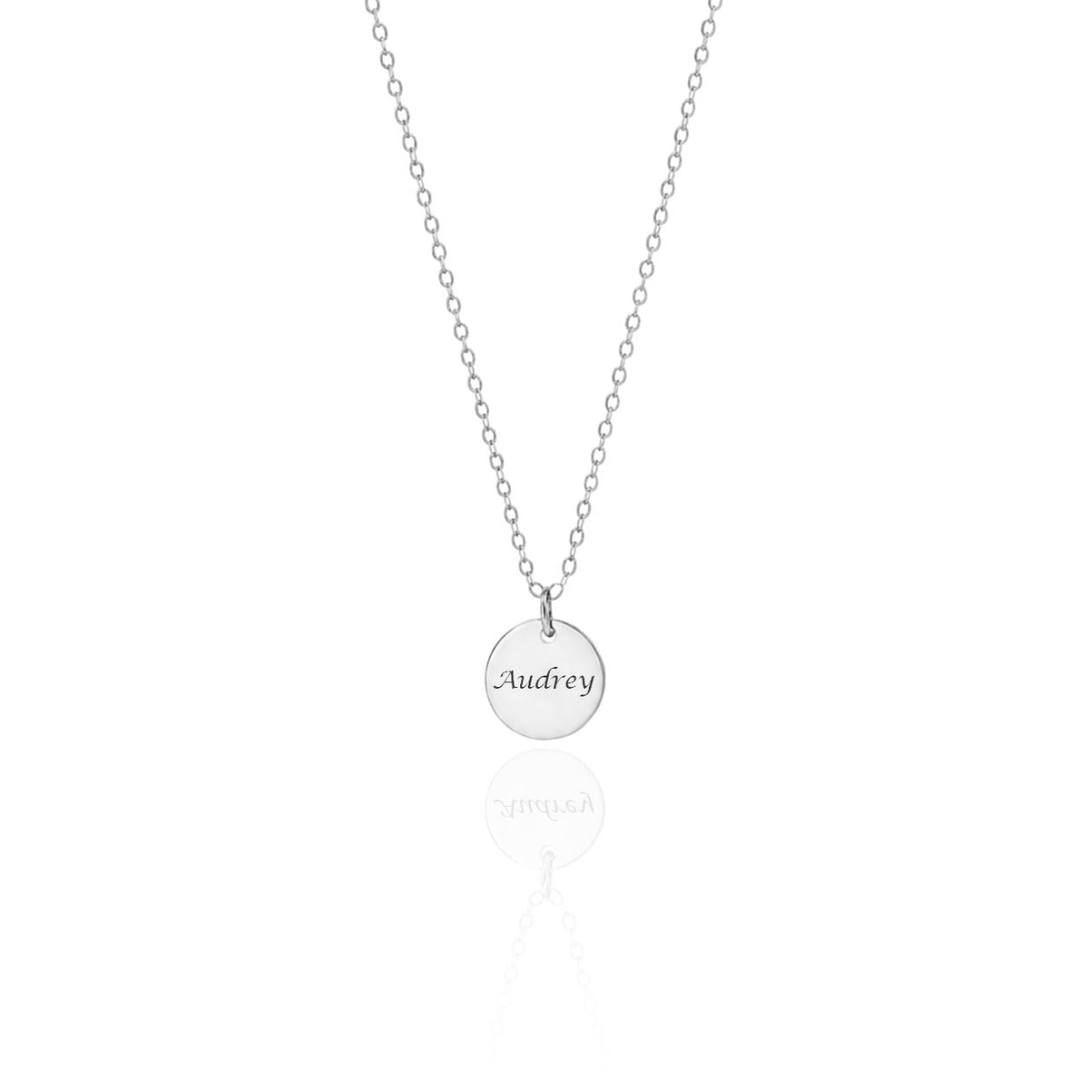 Silver-tone round disc necklace engraved Audrey on a white background