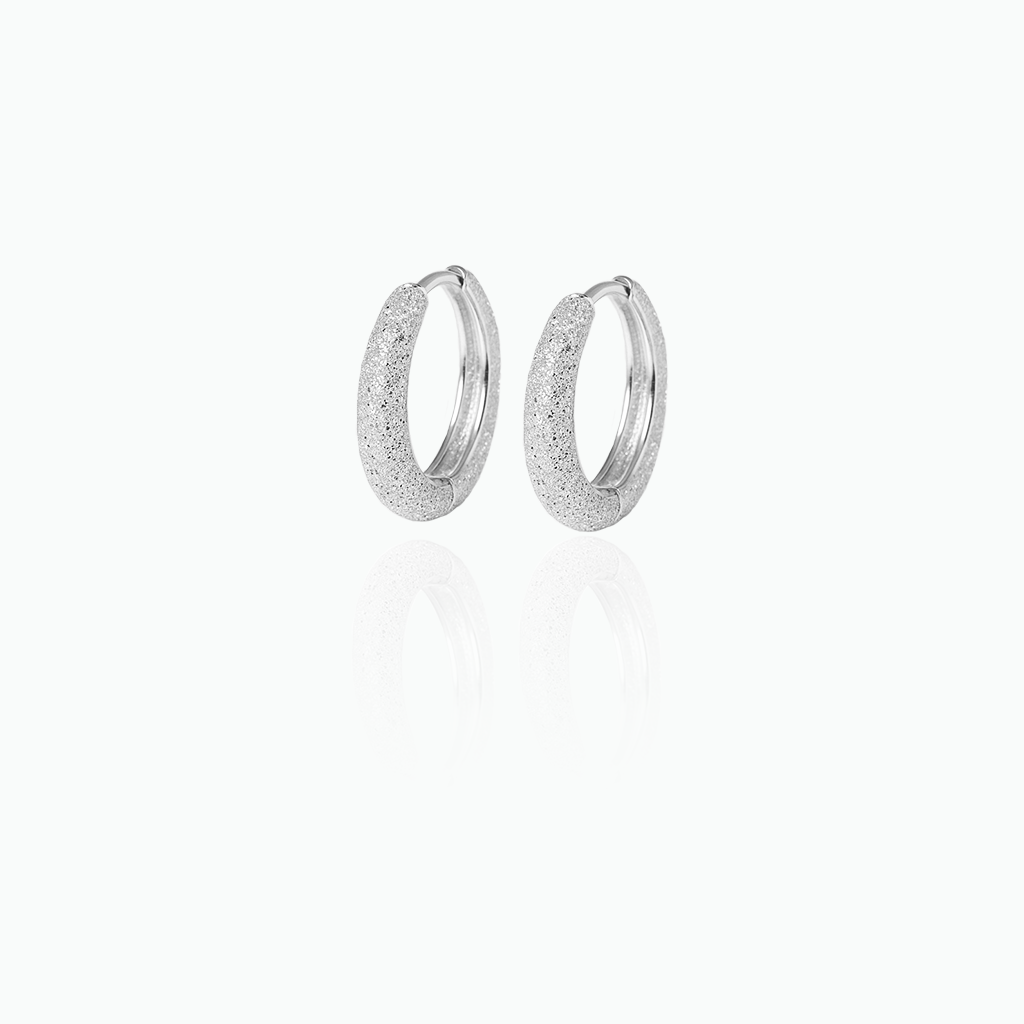 Silver hoop earrings on a white background