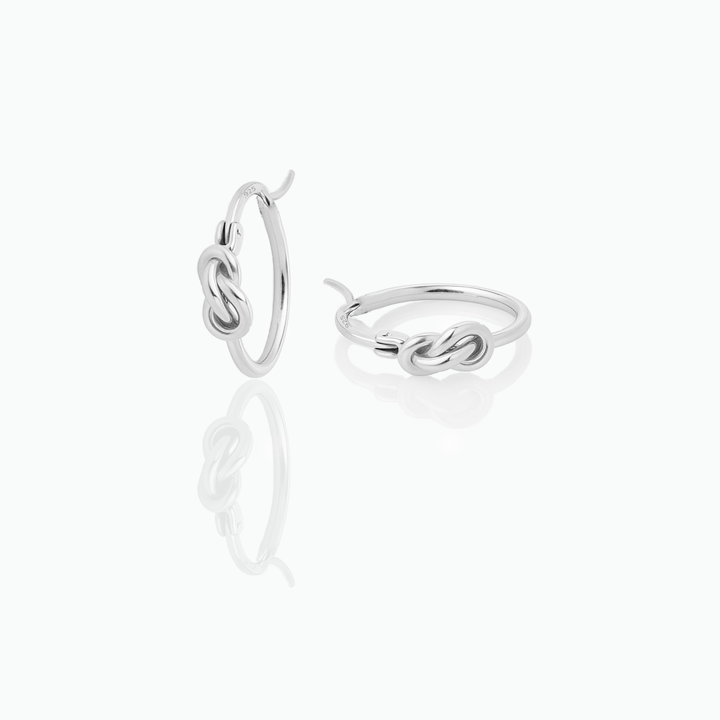 Silver hoop earring with interlocking design on a white background
