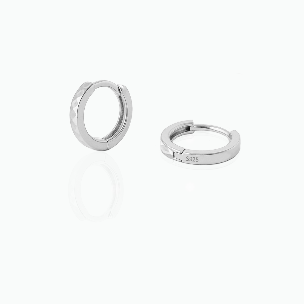 Pair of silver hoop earrings on a white background