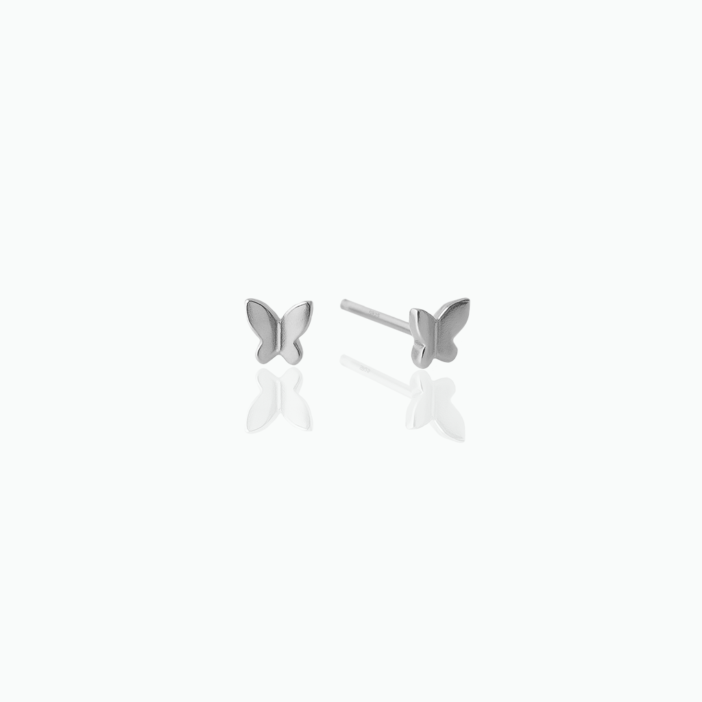 Butterfly-shaped silver earrings on a white background