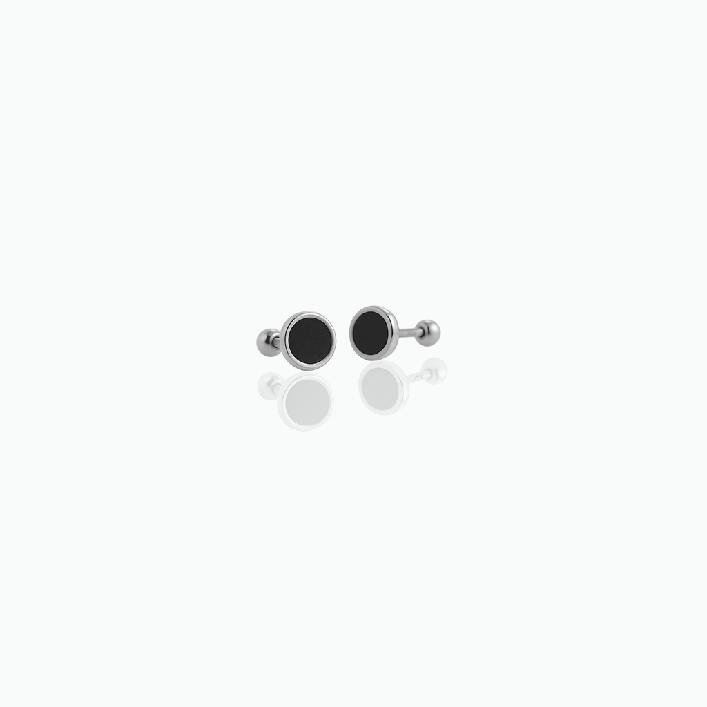 Pair of black and silver earrings on a white background