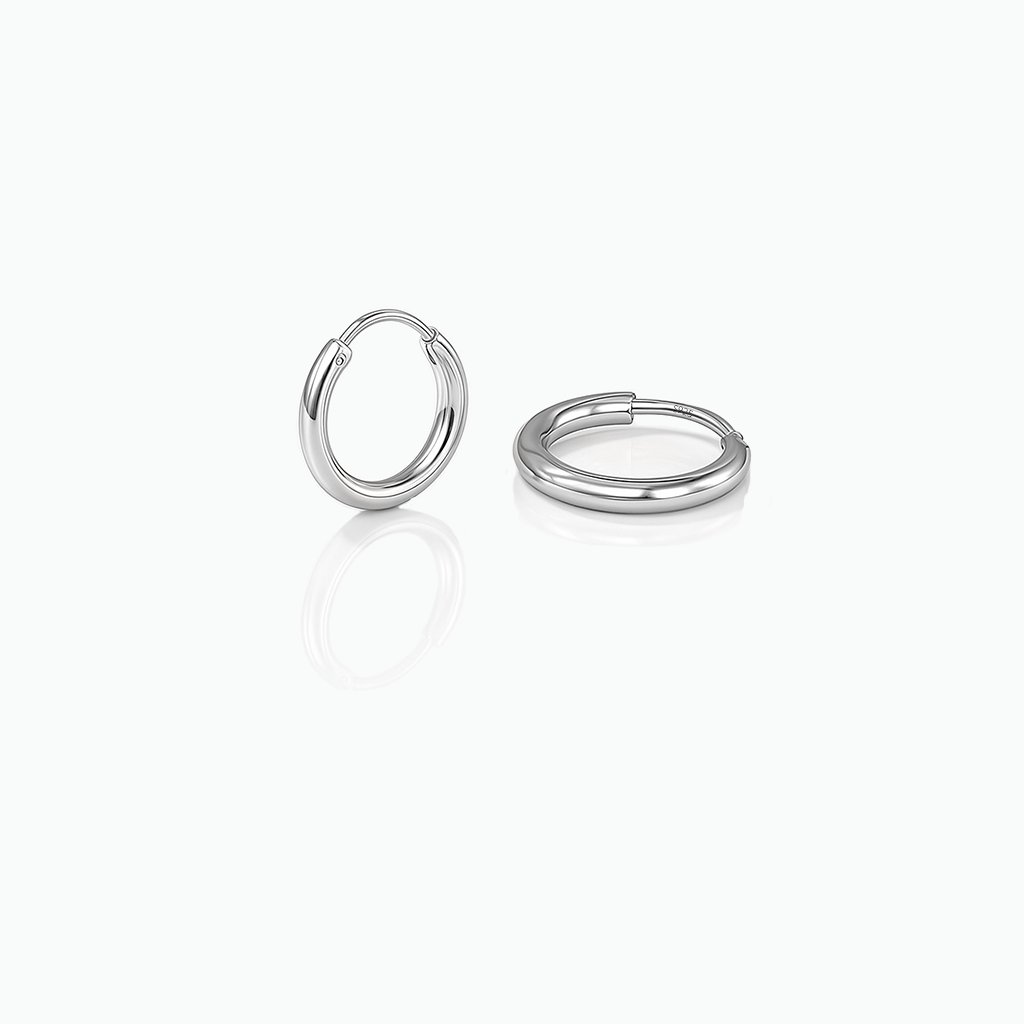 Two silver hoop earrings on a white background