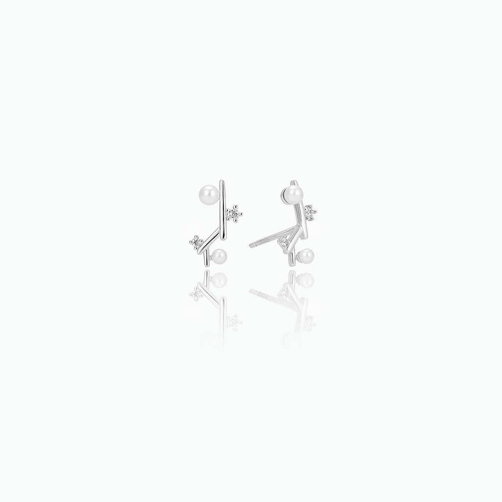 Pair of silver earrings with pearls on a white background