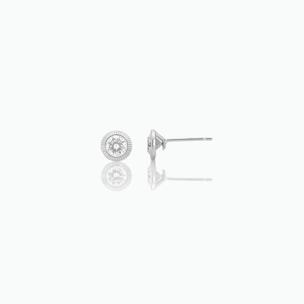 Silver-tone round stud earrings with clear center stones on a white background