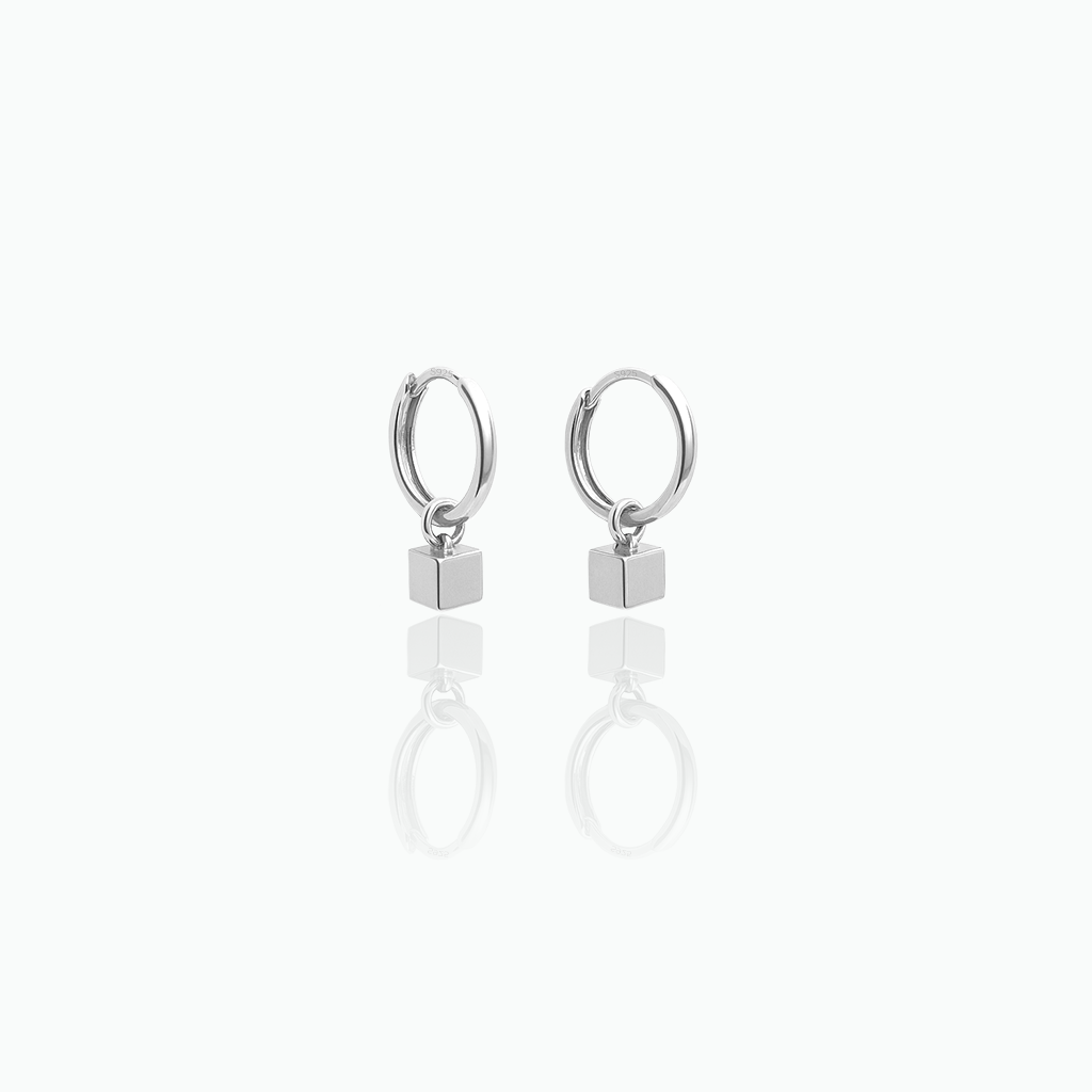 Silver hoop earrings with square charms on a white background