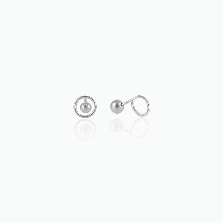 Pair of silver ball earrings on a white background