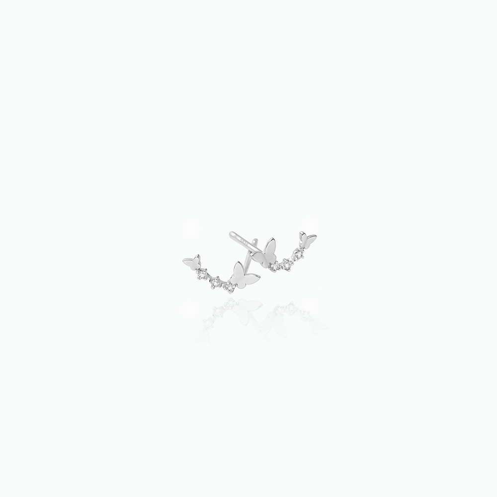 Silver butterfly earrings on a white background