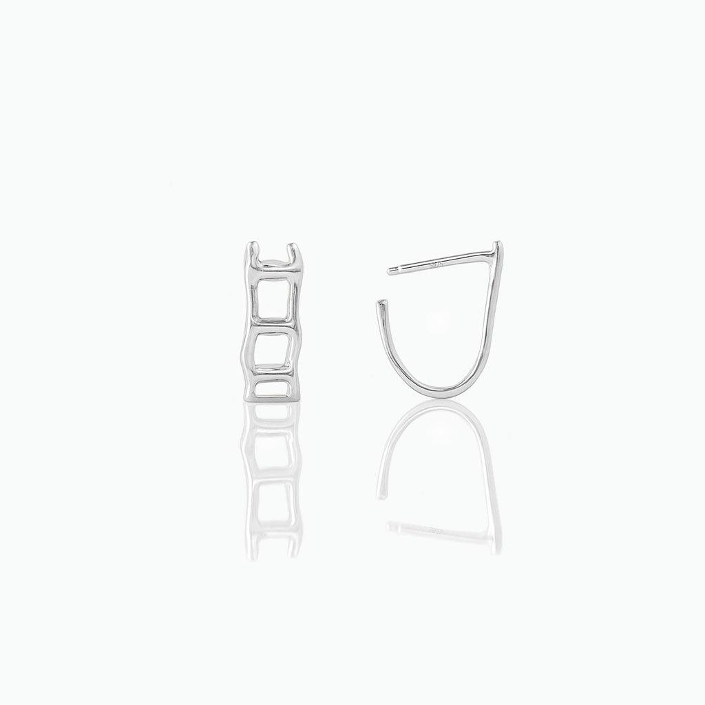Pair of silver hoop earrings on a white background