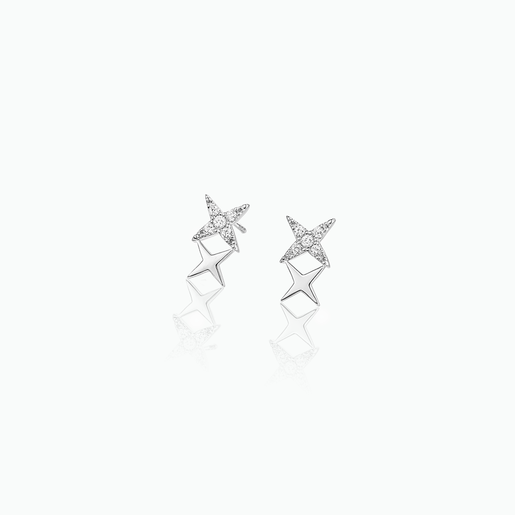Star-shaped silver earrings with small diamonds on a white background