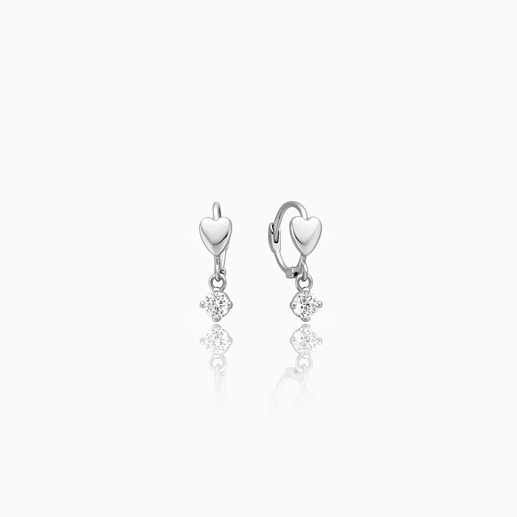 Silver heart-shaped earrings with small heart pendants on a white background