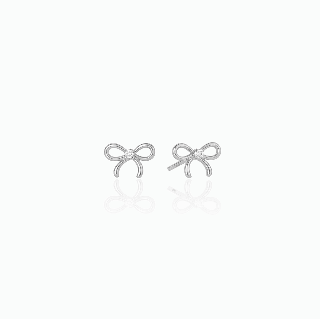 Silver bow-shaped earrings on a white background