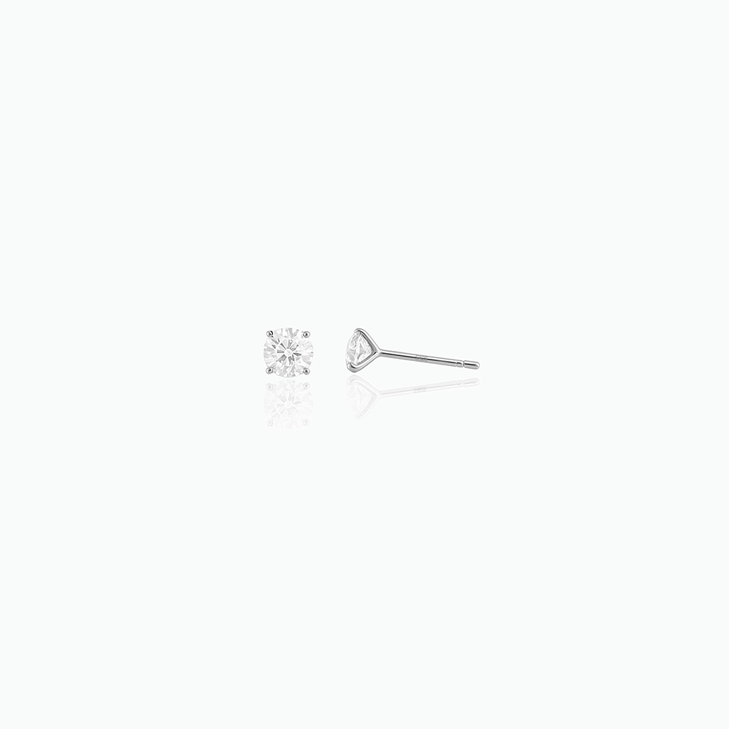 Two diamond earrings on a white background