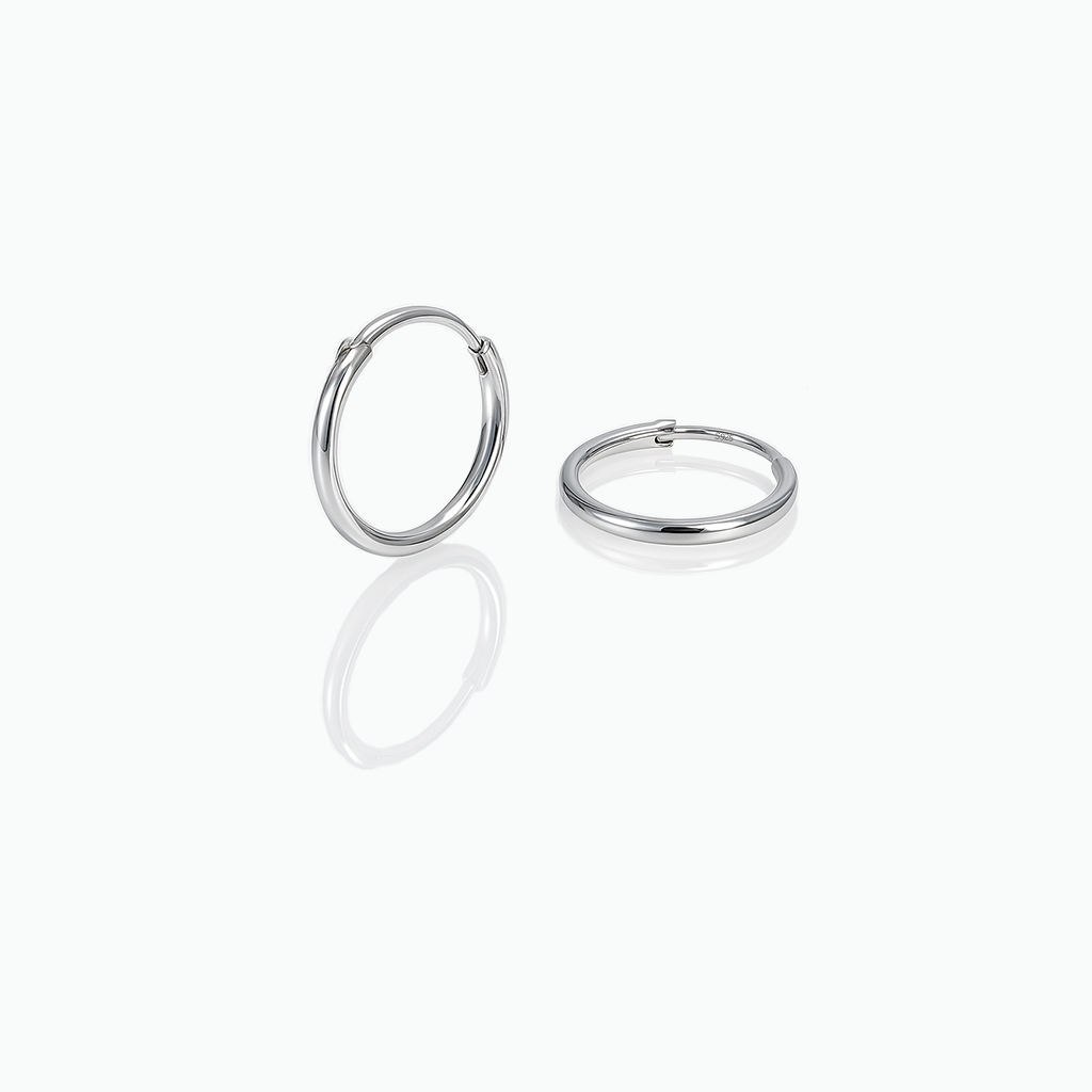 Pair of silver hoop earrings on a white background