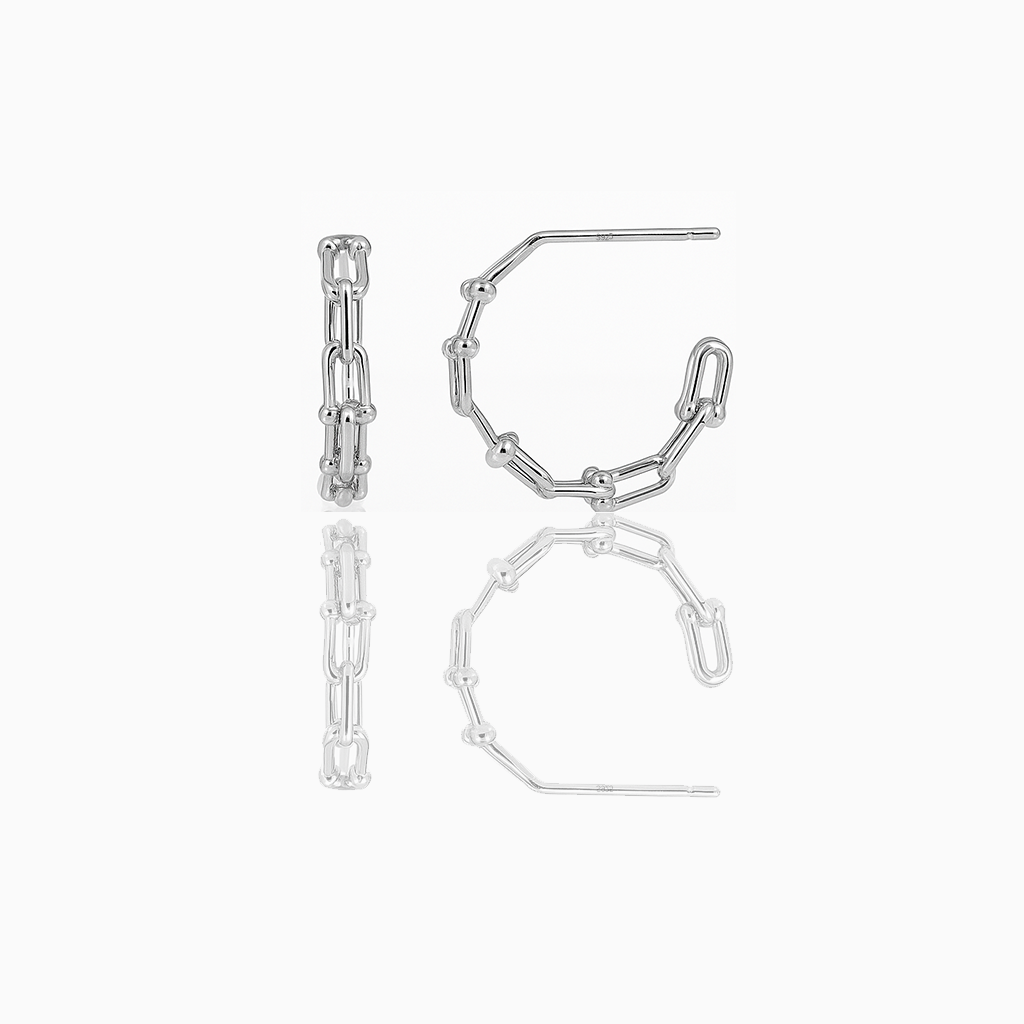 A pair of delicate huggie earrings made of gold vermeil, displayed against a white background.