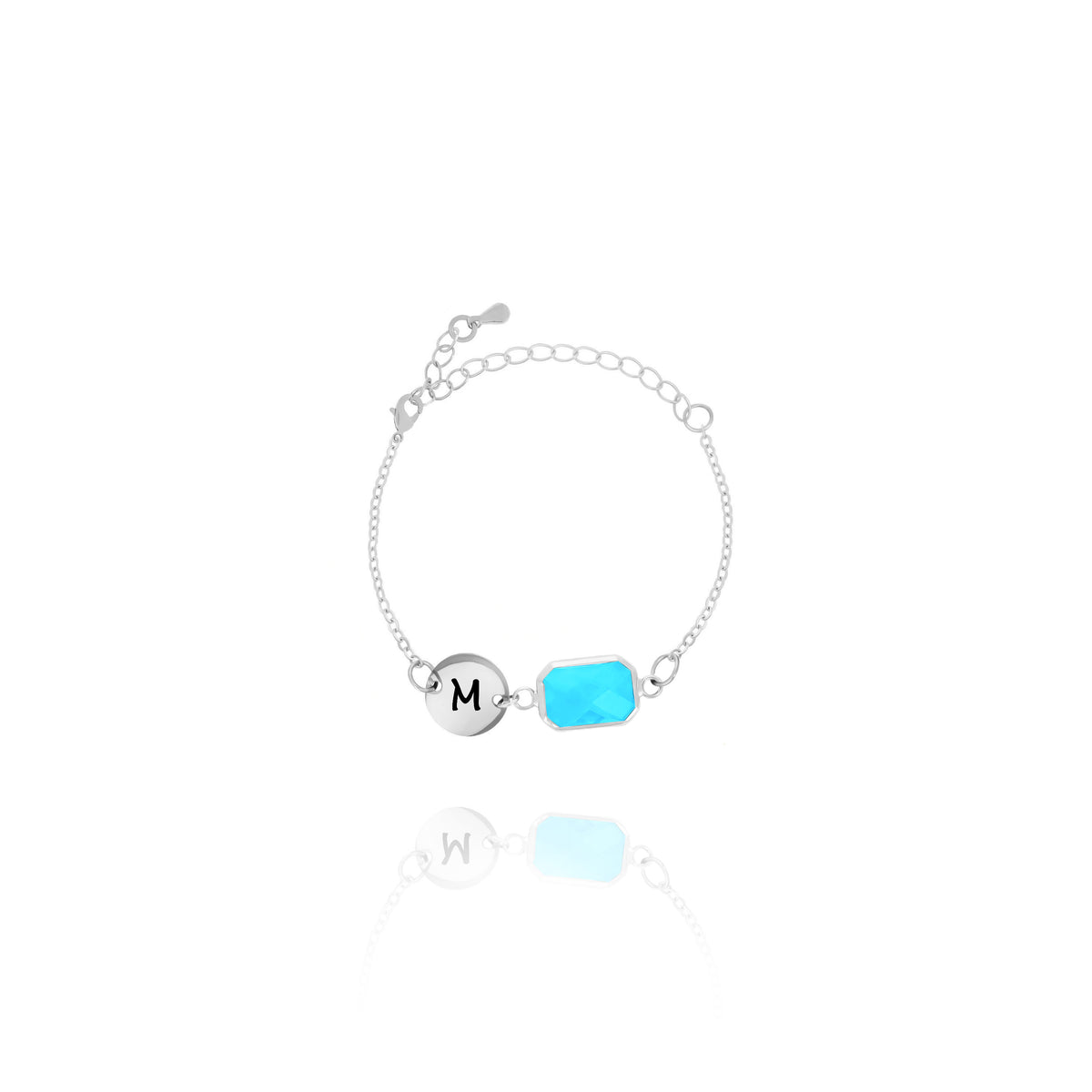 Silver-tone bracelet with engraved M initial disc and bright blue rectangular stone on white background