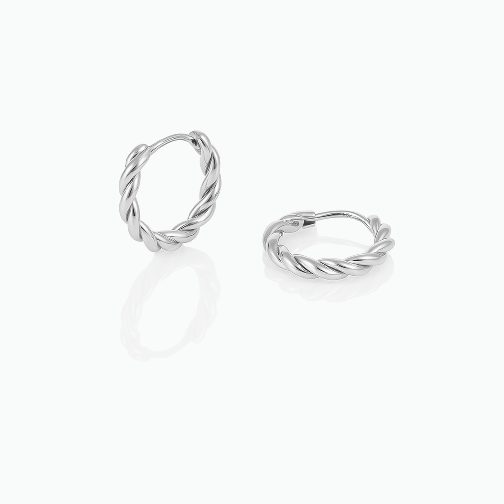 Pair of silver hoop earrings on a white background