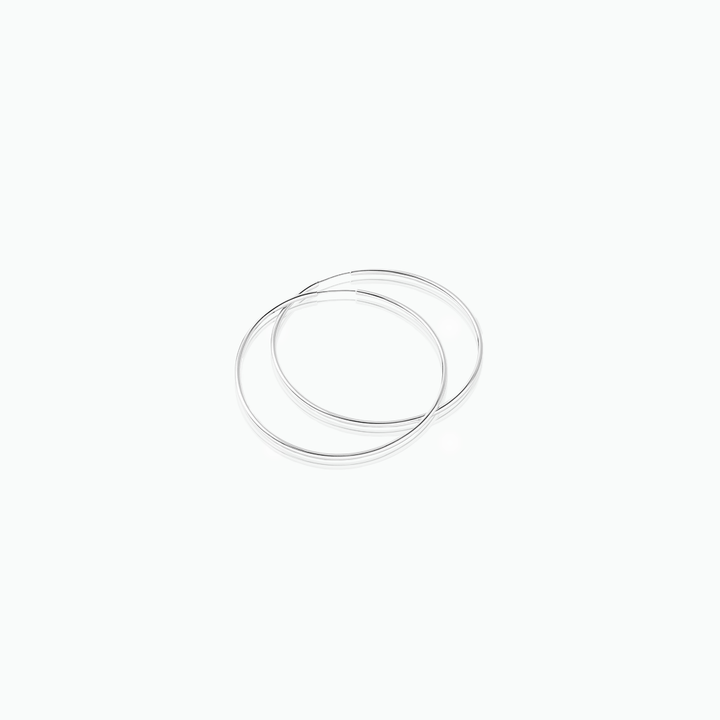 Silver hoop earrings on a white background