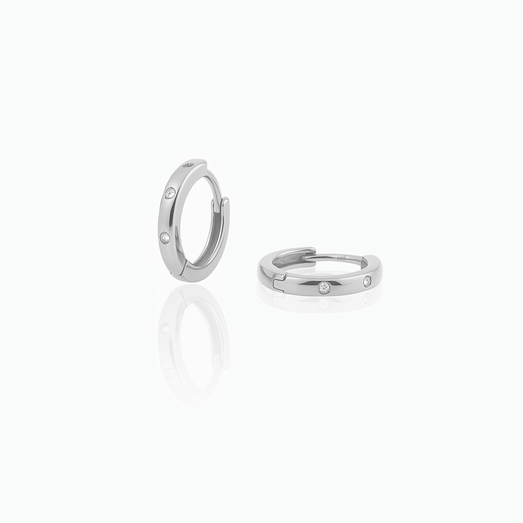 Pair of silver hoop earrings on a white background