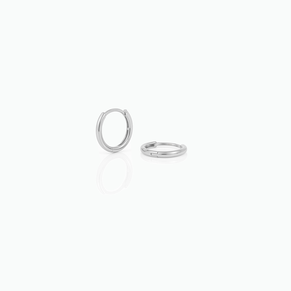 Two silver hoop earrings on a white background