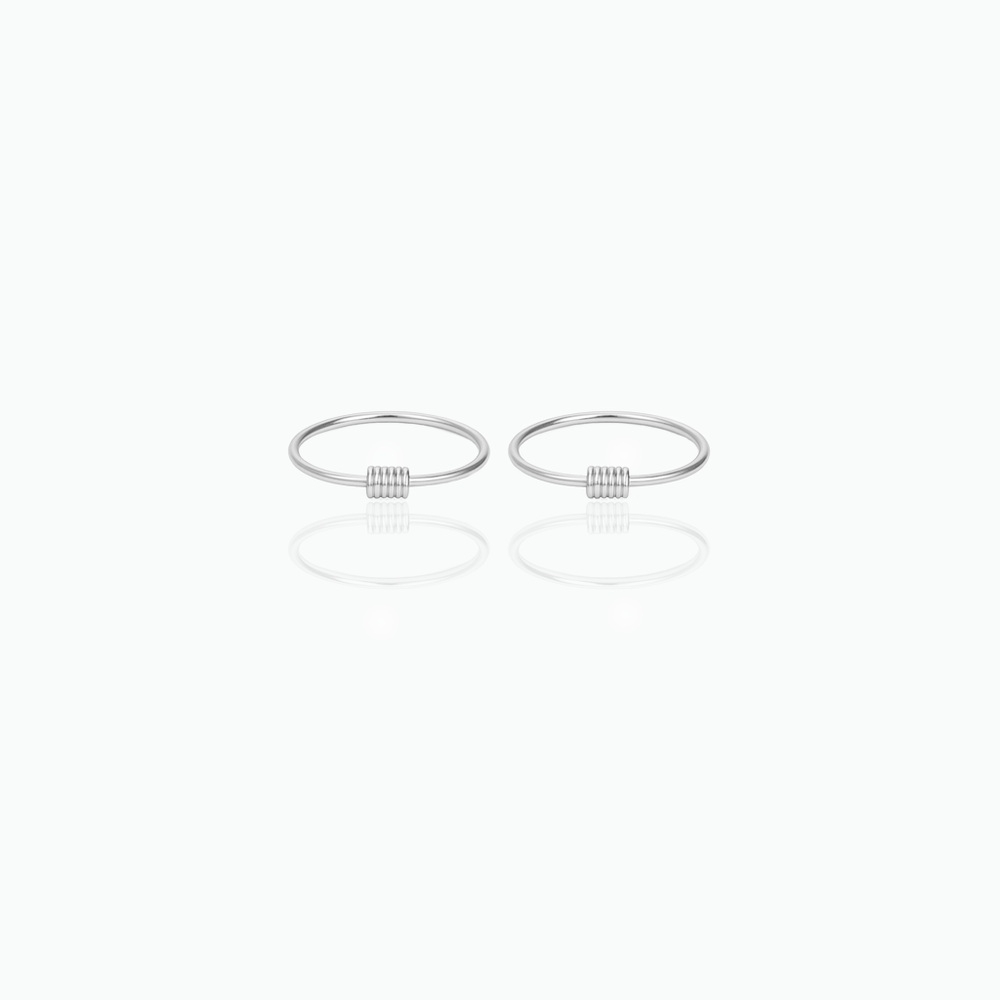 Two silver rings hoop earrings on a white background
