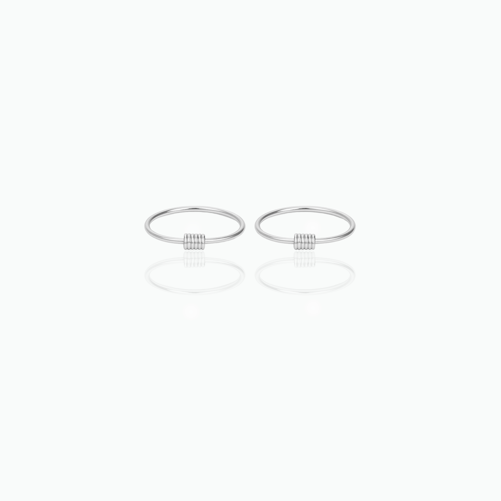 Two silver rings hoop earrings on a white background